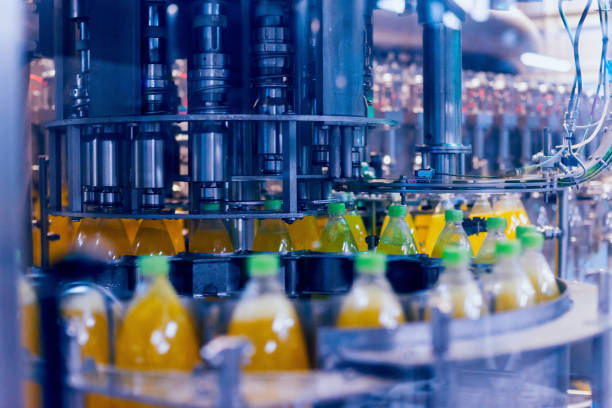 istock Automatic filling machine pours water into plastic PET bottles. Brewing production. 982401706