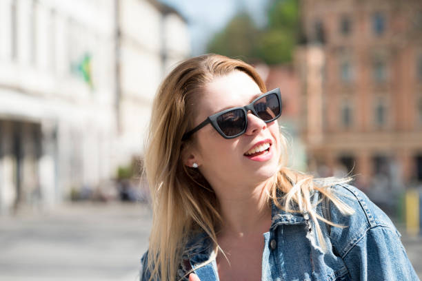 istock Young girl posing with black sunglasses 982404550