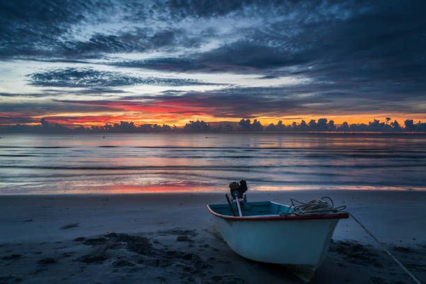 A boat in a Mediterranean beach of Ionian Sea at sunset - Bova Marina, Calabria, Italy