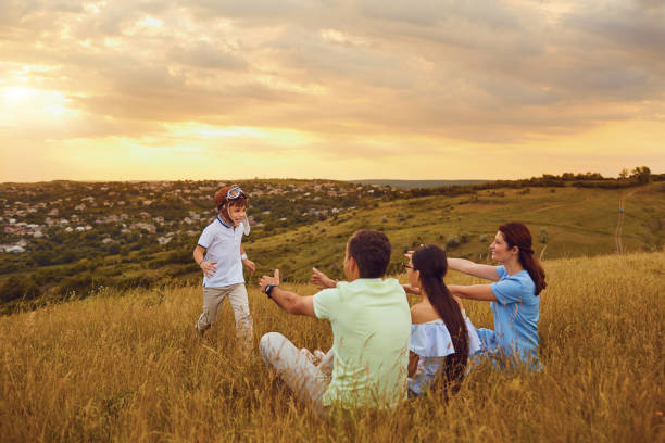 istock Happy family having fun playing on grass in nature 982407482