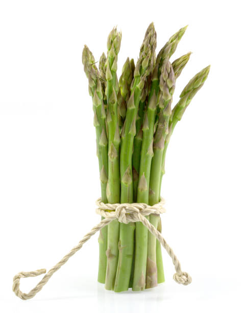 istock branches of fresh green asparagus isolated on white background, with clipping path. 982408172
