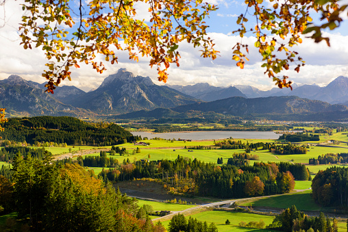 panoramic scene with lake Hopfensee and mountain range in region Allgäu in Bavaria