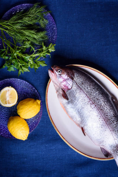 Whole fish being prepped for cooking. sea trout or salmon.