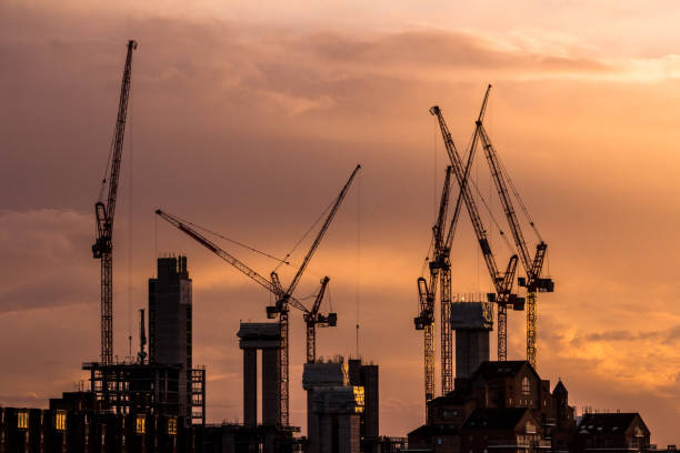 Cranes and construction equipment on London city skyline Color image depicting cranes and heavy duty construction equipment on the London skyline as the sun sets. The cranes have been busy constructing blocks of flats and apartments to ease the housing crisis in London and the south east of England. Lots of room for copy space. wandsworth photos stock pictures, royalty-free photos & images