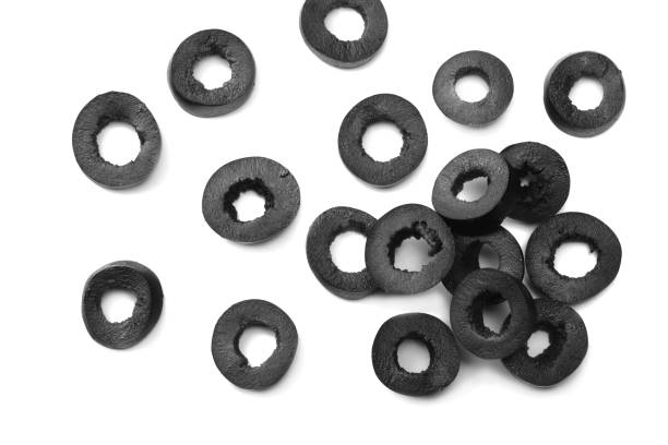 istock Marinated slices black olives isolated on white background. top view 982436276