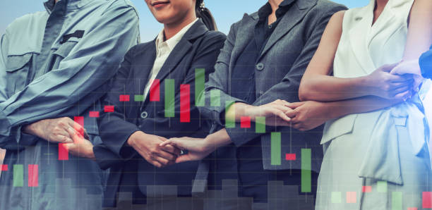 istock Double exposure business people holding hands. 982437002