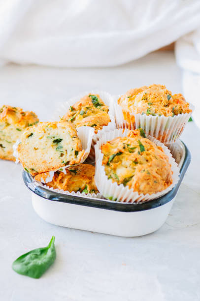 istock Savory potato spinach and feta muffins. White stone background. 982442944