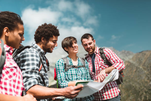 istock friends checking the map on top of mountain 982443258