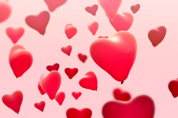 istock red heart shape ballons on pink background 982443334