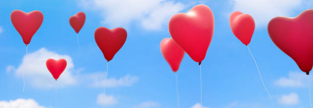 istock red heart shape balloons on blue sky panorama 982443542