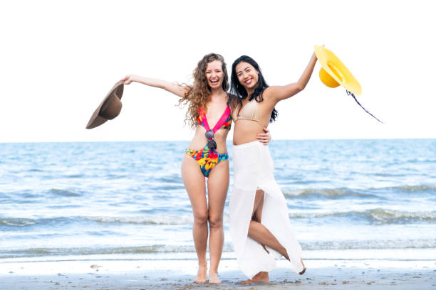 istock Happy women dance on sand beach in summer. 982444044