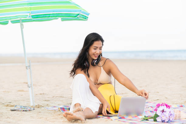 istock Plus size young woman sitting on the beach. 982444060