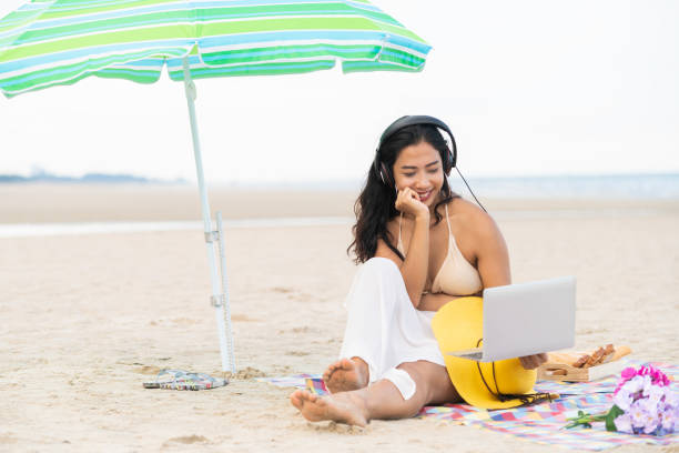 istock Plus size young woman sitting on the beach. 982444064