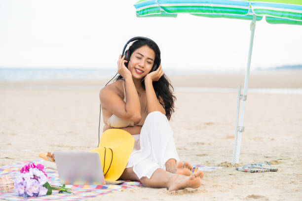 istock Plus size young woman sitting on the beach. 982444066