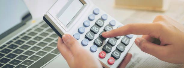 istock Woman accountant or bank worker uses calculator. 982444116