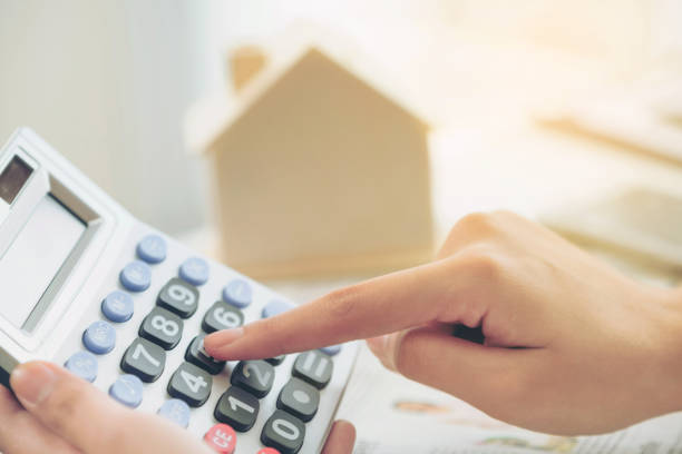 istock Woman accountant or bank worker uses calculator. 982444150