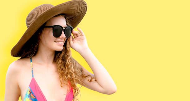 istock Woman in swimsuit posing on color background. 982445304