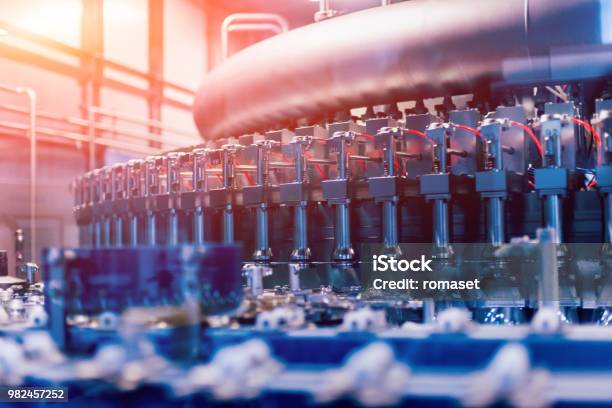 Automatic Filling Machine Pours Water Into Plastic Pet Bottles Brewing Production Stock Photo - Download Image Now