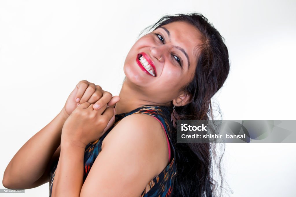 A Young Indian Women Wearing A Black Sleeveless Dress Making Funny Faces  And Teasing With Naughty Expressions Isolated Against A White Background  Stock Photo - Download Image Now - iStock