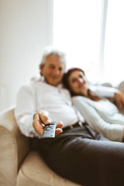 istock senior couple resting on the sofa 982464652