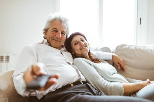 istock senior couple resting on the sofa 982465726