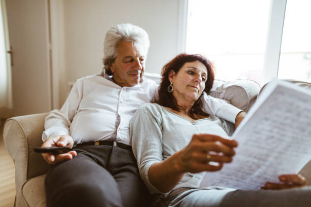 istock senior couple resting on the sofa 982465818