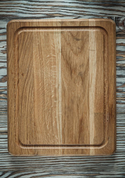 istock Chopping board on vintage wooden surface 982488018
