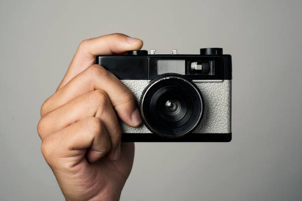 istock man with a film camera in his hand 982498060