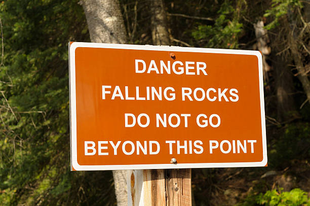 istock Warning sign stating danger of falling rocks 98250150