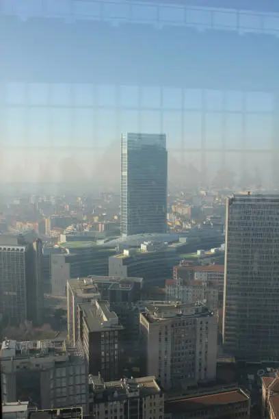 Photo of window on top of a skyscraper with a view of Milan