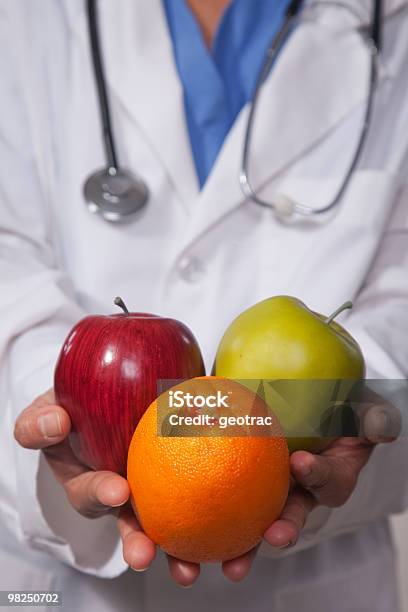 Doctor Recommending Healthy Diet Stock Photo - Download Image Now - Advice, Apple - Fruit, Color Image