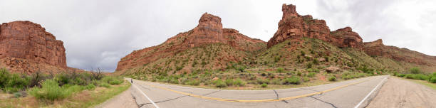 istock Utah road and incoming storm, panorama. Note the person. 982510668