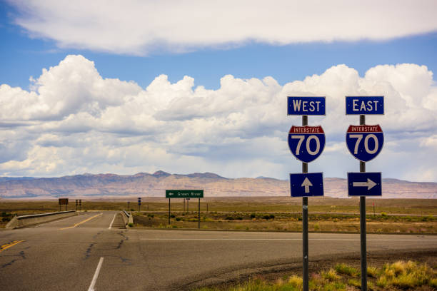istock Utah highway road crossing, mountains in background 982513264