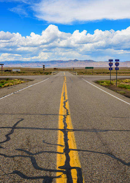 istock Utah highway road crossing, mountains in background 982513290