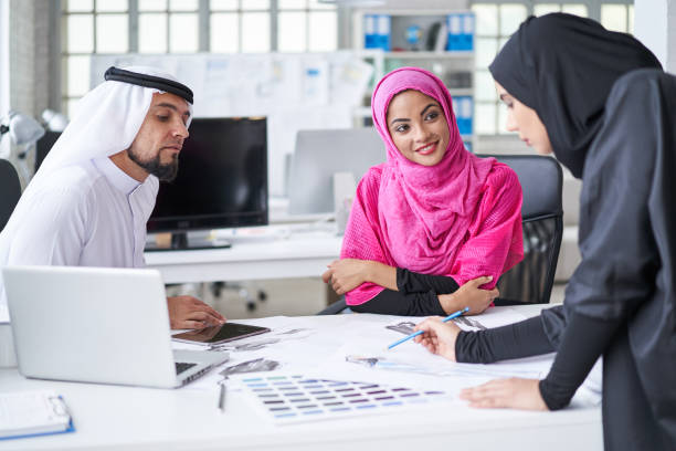 istock Team discussing and brainstorming in modern office 982519174