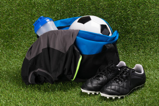 istock blue bag with a set for playing football on green grass 982523030