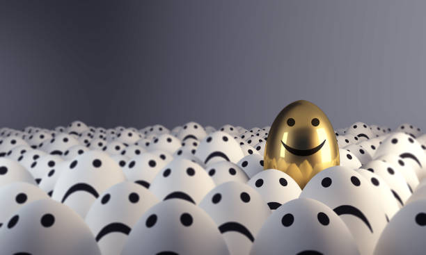 istock Happy Golden Egg Standing Out From The Crowd 982533062