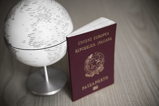 Close-up of passport with globe, travel concept