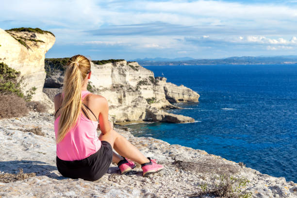 istock Pretty woman sitting at cliffs in Bonifacio 982540014