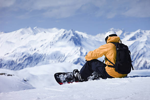 young  snowboarder woman at ski resort