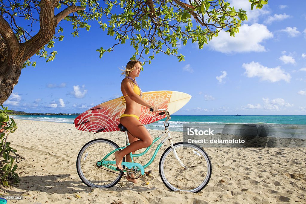 young girl on her bicycle with surfboard  Bicycle Stock Photo