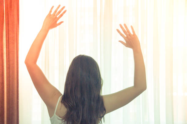 istock Woman stretching in bed after wake up 982548432