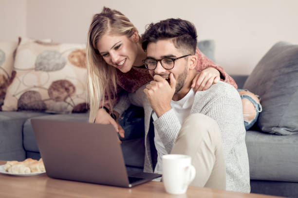 istock Cheerful couple enjoying at home 982548948