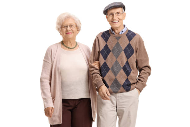 Elderly couple looking at the camera and smiling isolated on white background