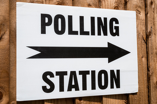 A sign pointing in the direction of a Polling Station on election day in the United Kingdom.