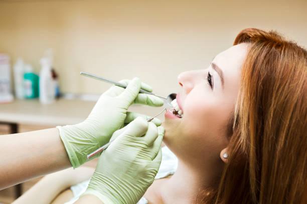 istock Young woman at dentist checking cavities 982554902