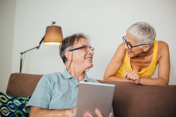 istock Mature woman leaning on sofa and looking at her man 982559240