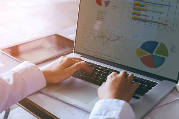 istock Close up businessman hand working on  laptop computer and analyzing market graphs. 982561168