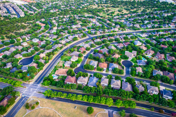 istock aerial drone view looking straight down from above Intersection at Road and Urban Modern Suburb houses and homes colorful rooftops 982588394