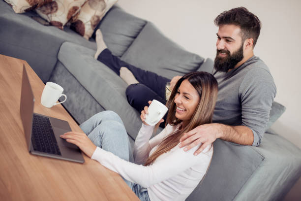 istock Cheerful couple enjoying at home 982588450